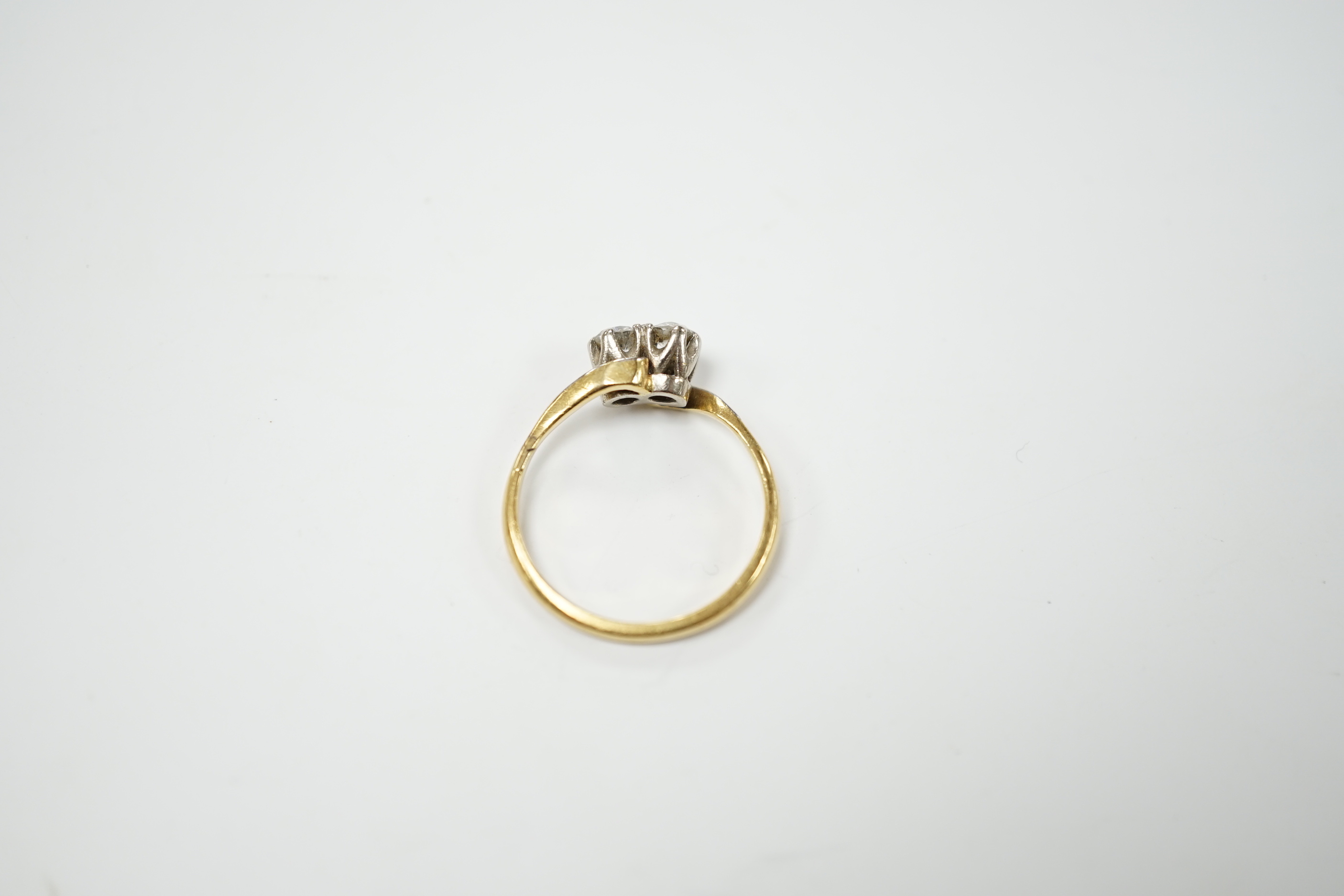 An 18ct gold and platinum two stone diamond ring, size M